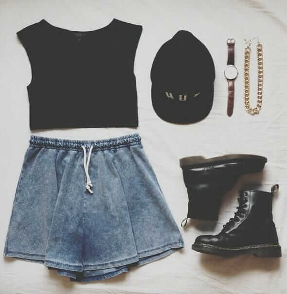 Grunge outfit idea nº9: Black cap, black T, Black Doc Martens, denim print shorts, brown watch, thick banded gold chain necklace