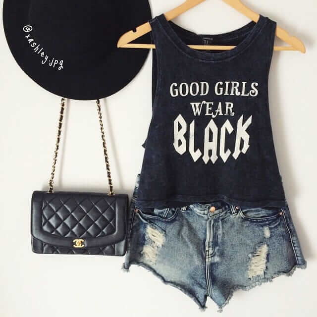 Black statement singlet with ripped jean shorts, a sleek jet black brimmed hat, and a black Coco Chanel handbag