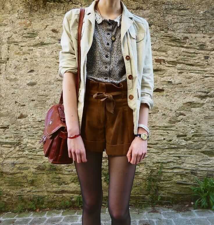 Brown suede shorts, flowery shirt, denim jacket and brown leather handbag