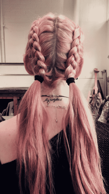 Long pink dyed braided hair with ponytails