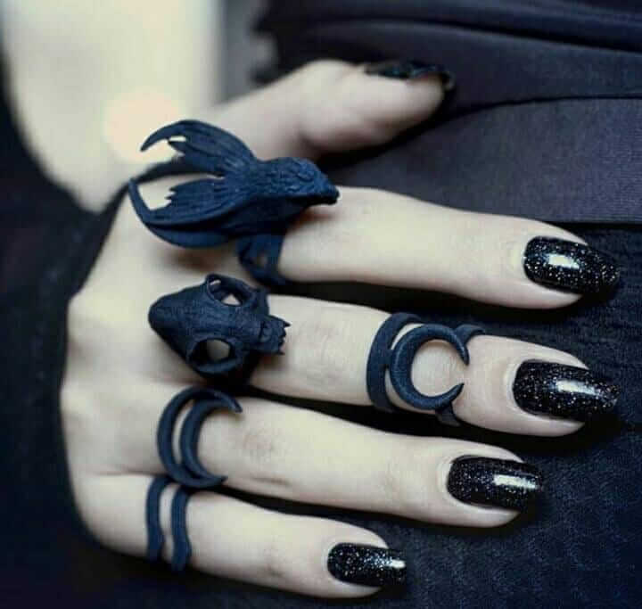 Black glitter nails with goth rings