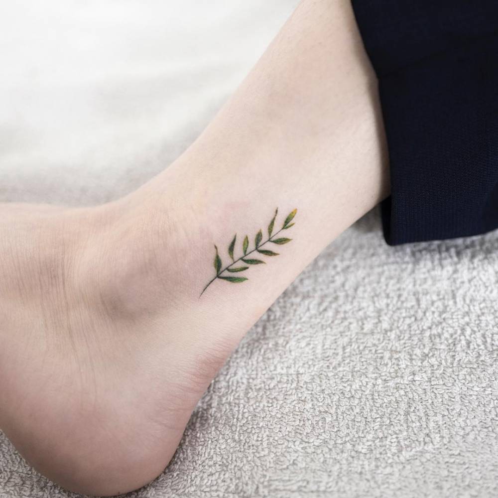 Minimalist leaf tattoo on the ankle