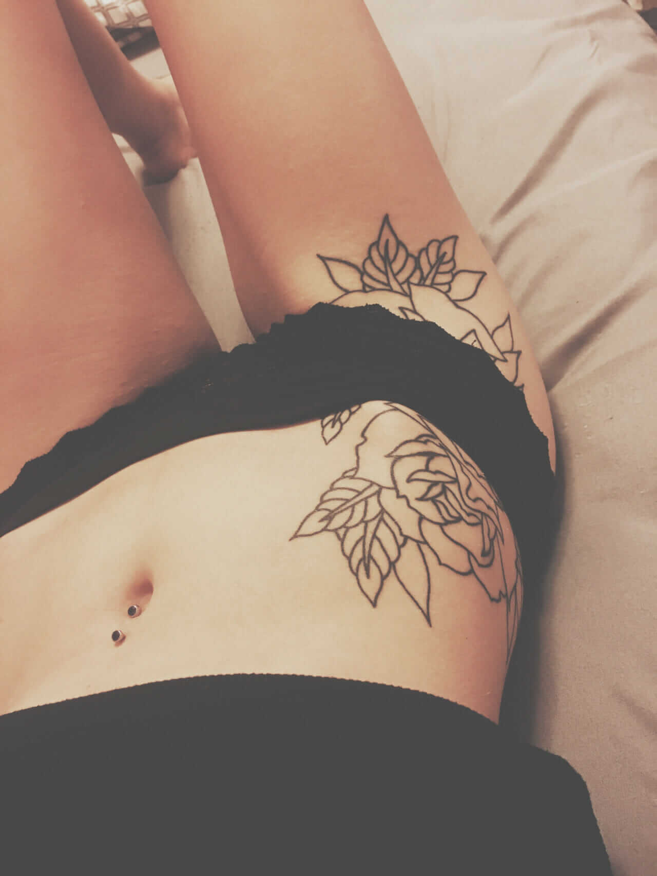 Tina Cantina's rose tattoo hip