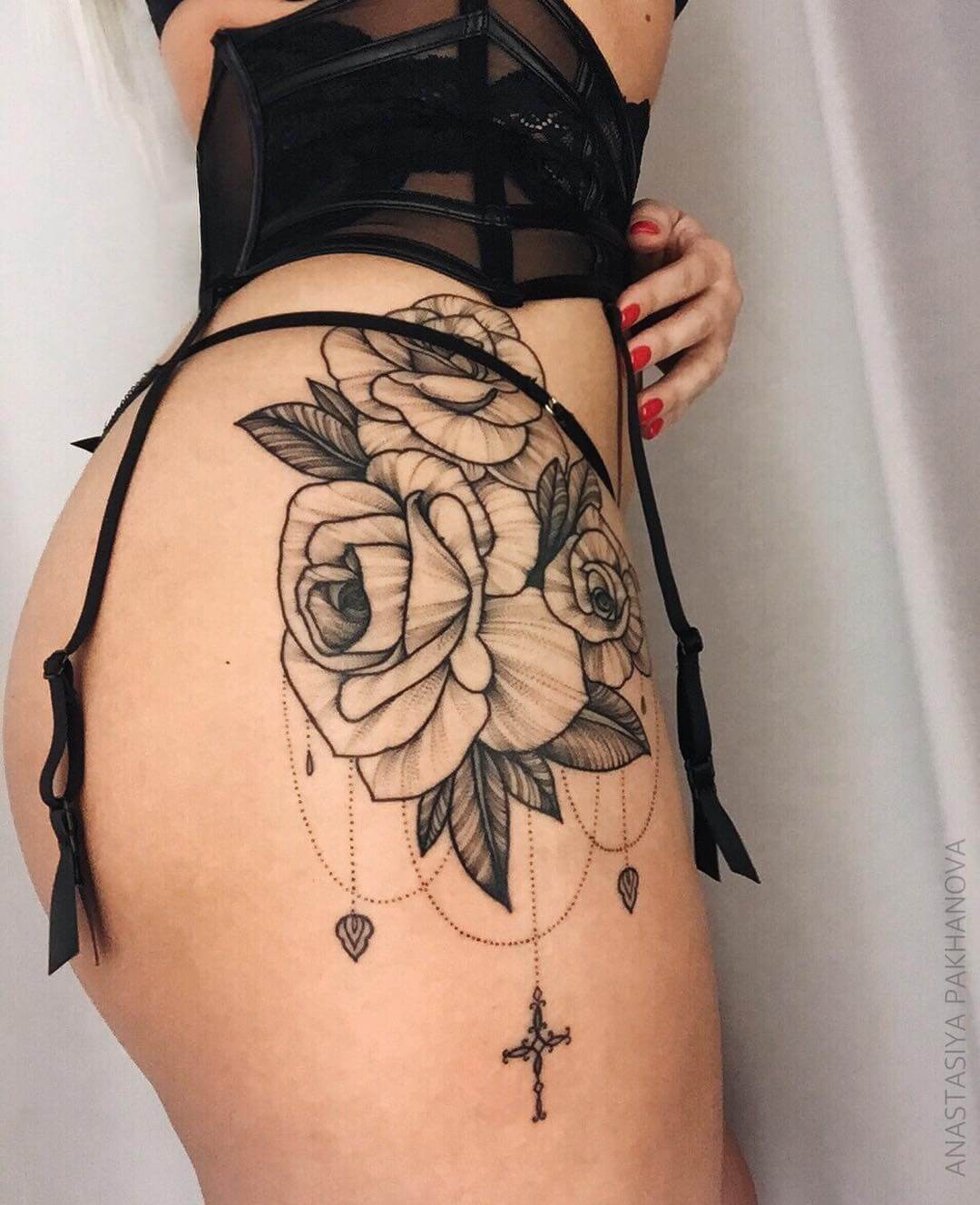Rose flowers tattooed on hip with cross necklace by pakhanova