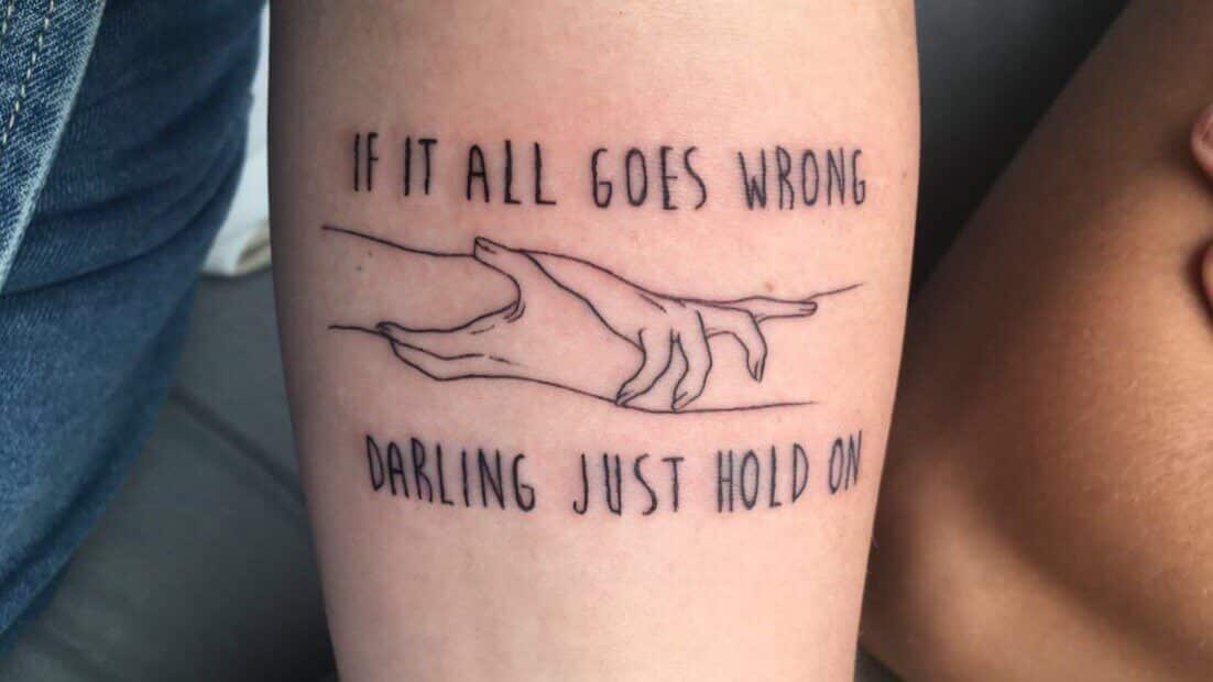 "If it all goes wrong darling just hold on" quote with graphic tattoo