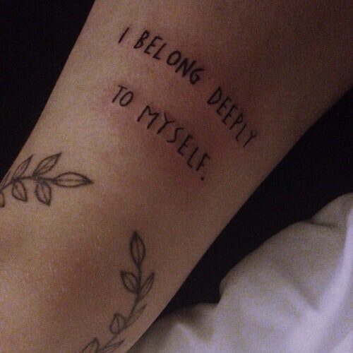 "I belong deeply to myself" arm tattoo quote