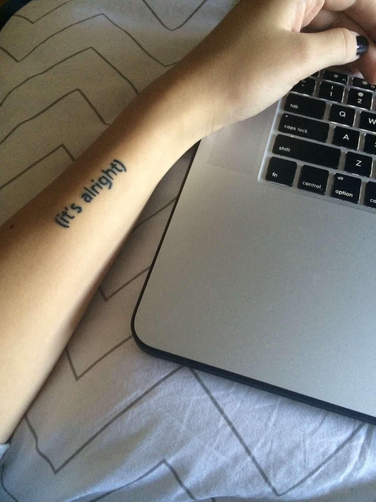 "(it's alright)" arm quote tattoo
