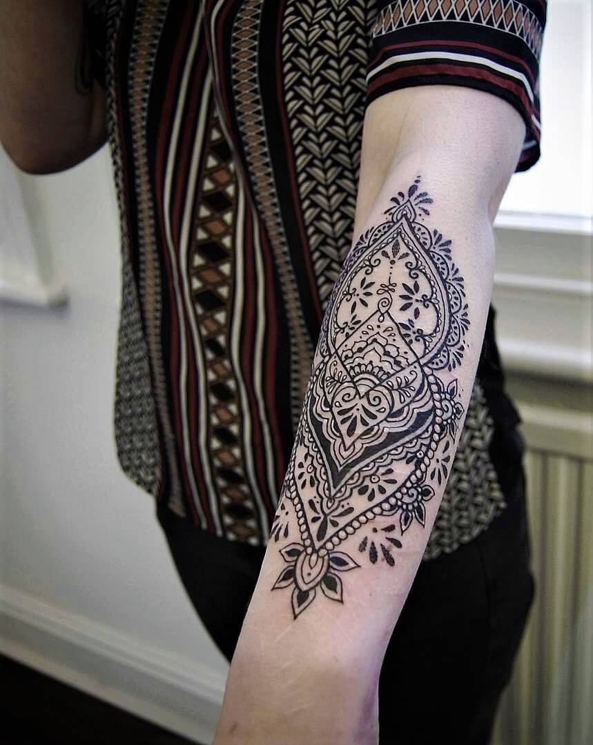 Half sleeve lower arm floral tattoo