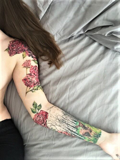 Flowers and deer colored sleeve tattoo