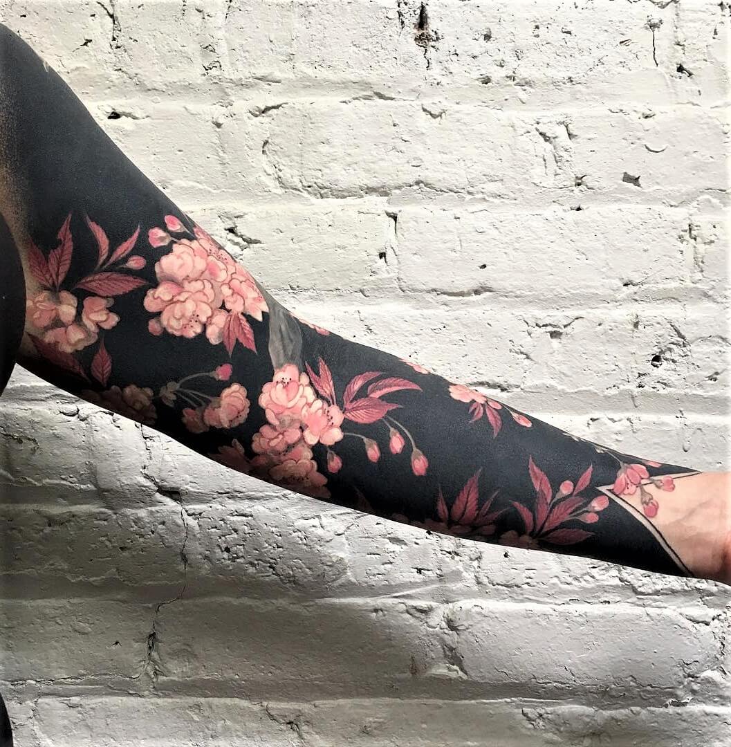 Flowers and blackout sleeve tattoo