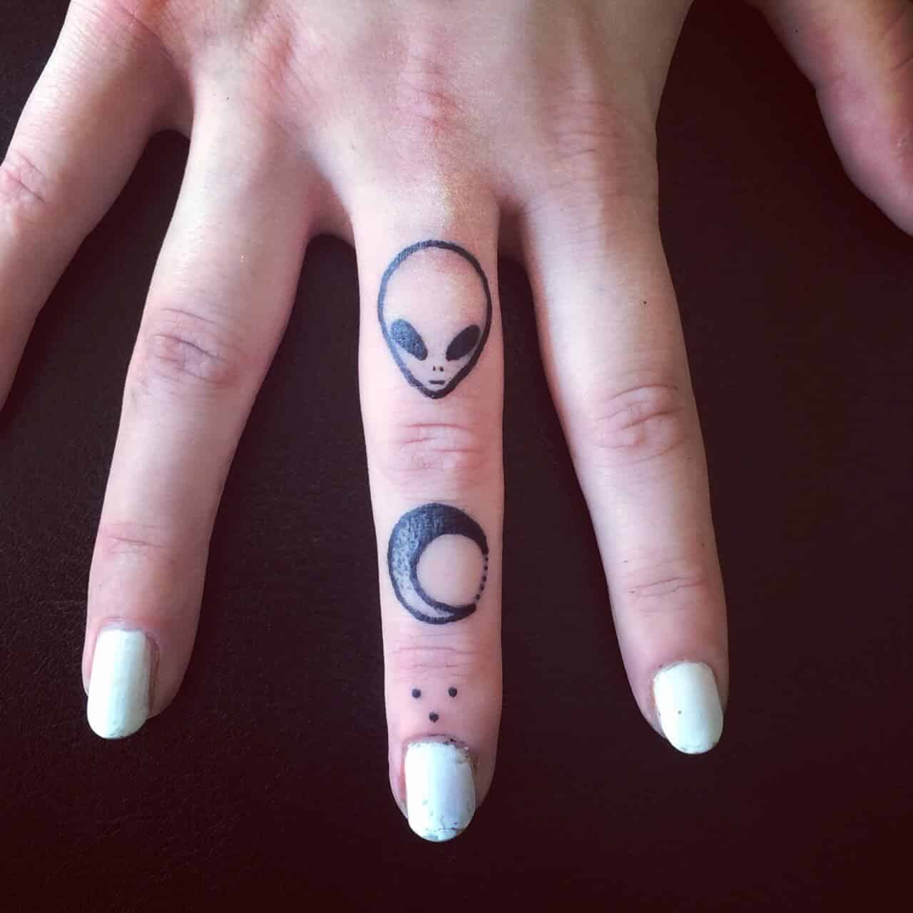 Middle finger alien head tattoo