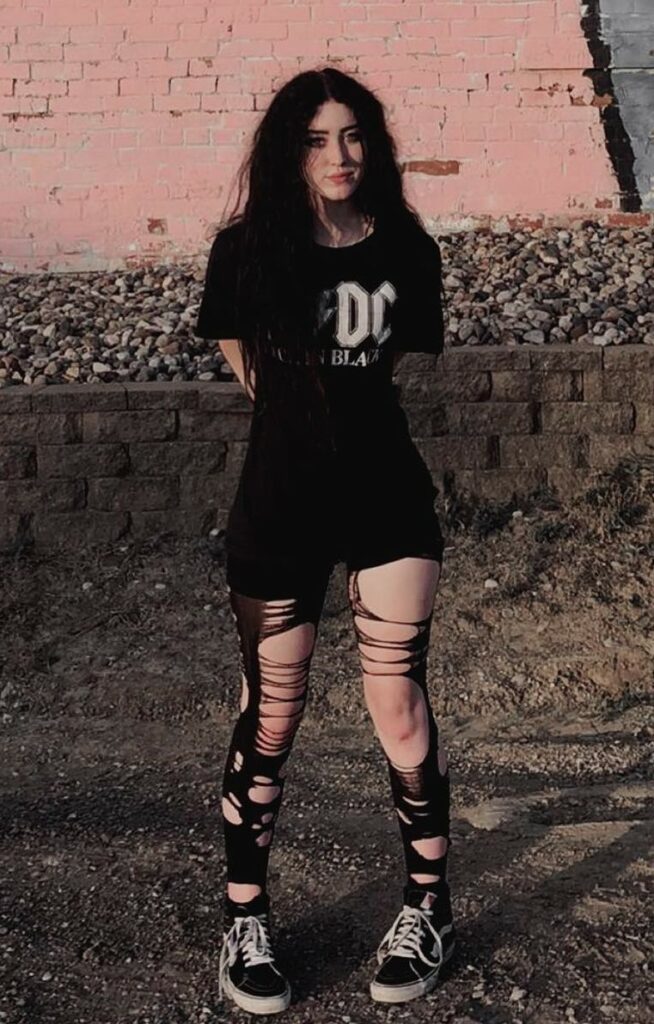 AC/DC oversized tee with black shorts, ripped pantyhose & Vans sneakers by jadynixx
