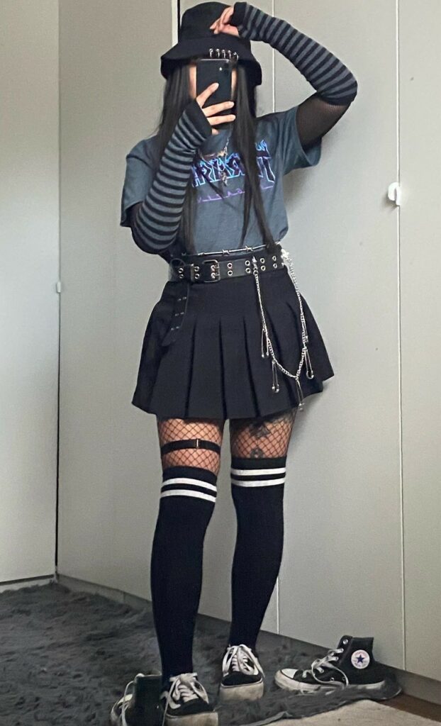 Trasher Magazine top with long striped hand warmers, pleated mini skirt with double rings belt, fishnet tights, long striped socks & vintage Converse shoes by mithara.bui